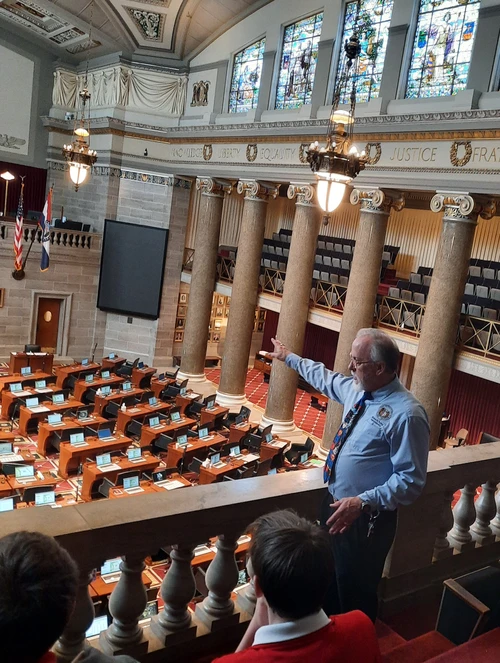 Taney County Representative Brian Seitz visits with the students as they are led on a tour through the Capitol building.